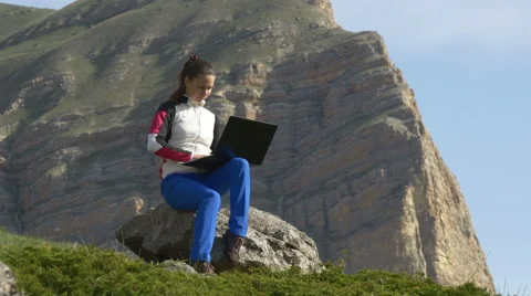 Student in the mountains working at a computer Video stock 63370946