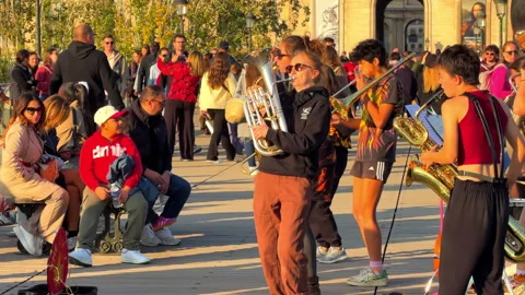  Student musicians performing lively jazz and brass on Pont des Arts in Paris Видео 337880464