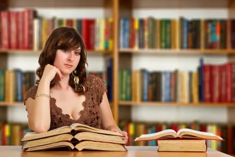 Student with open book reading it in college library Stock Photos