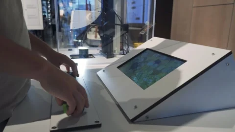 A student operates an electron microscope and looks at the results on a tablet Video stock 256801368
