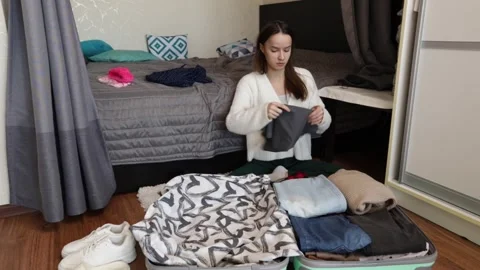 Student Packing for Vacation with Open Suitcase in Bedroom Stock Footage 307757353