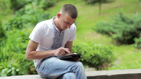 Student in the park s tablet Video stock 67566666