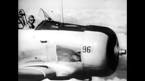 A student pilot executes a slow roll aerial maneuver while flying a trainer Stock Footage