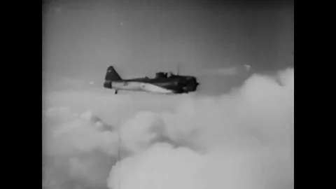 A student pilot uses a high rudder technique and executes a slow roll aerial Stock Footage