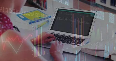 Student in pink top coding on laptop at home study desk, textbooks and Foto stock