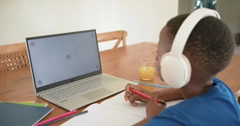 Student is placing red pencil on notebook on table, writing homework notes while Stock Footage 340010943