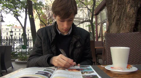Student planning a vacation, outdoor cafe, tourism, guide, accommodation Stock Footage 32503049