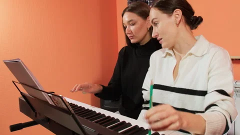 Student playing becomes refined under teacher guidance Stock Footage 307043150