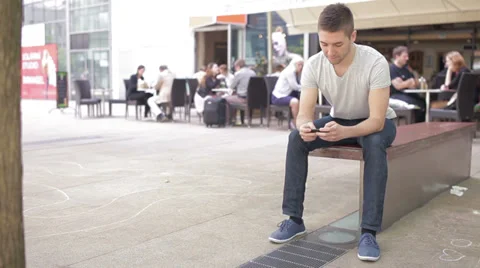 Student playing with electronic device, coffee place in the background Stock Footage 39343167