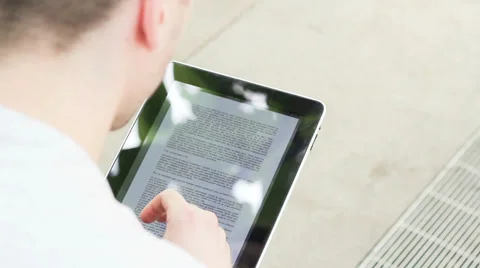 Student playing with electronic device, reading Stock Footage 39343192