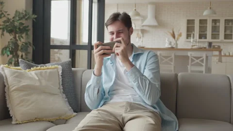 Student Playing Mobile Game On Smartphone, Trying Hard And Finally Winning Stock Footage 301247282