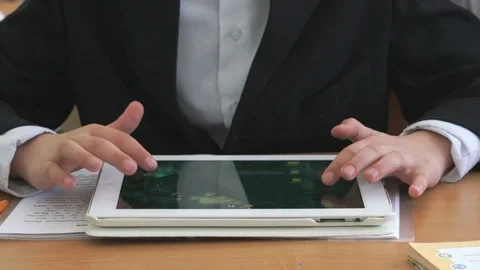 Student plays in games using white computer tablet Stock Footage 78114137