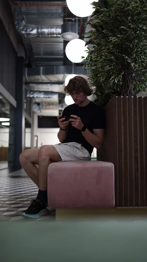 Student plays phone games instead of studying and procrastinates on schoolwork Stock Footage 345361105