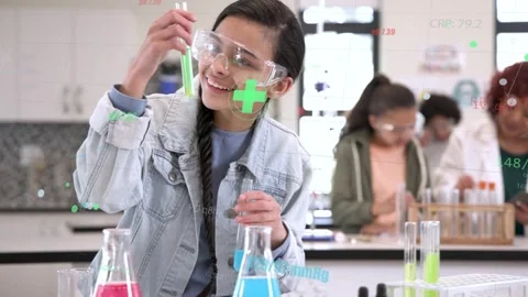 Student positioning flasks, pouring blue into green test tube in school lab, Stock Footage 333999636