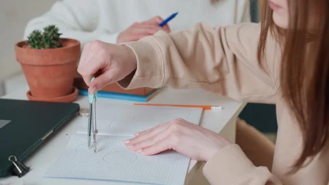 Student practices geometry. Student carefully uses compass during study Stock Footage 341976389