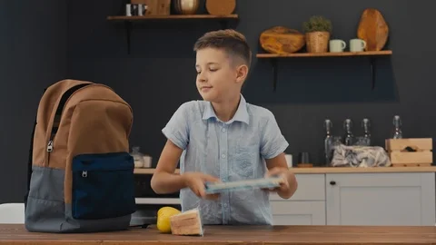 Student prepares backpack for school. Back to School. Stock-Footage 92839835