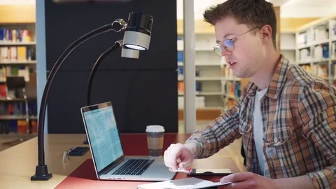 The student prepares for the exam in the reading room of the library Stock Footage 80631637