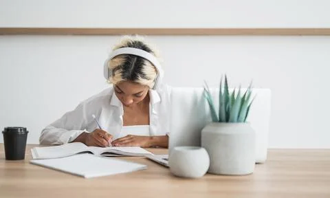 Student preparing for college test, exam, writing notes, making summary for Stock Photos