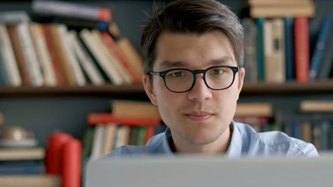 Student preparing exam and learning lessons in school library, making research Stock Footage 97556225