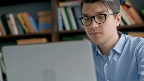 Student preparing exam and learning lessons in school library, making research Stock Footage 97557853