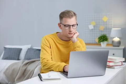 Student preparing for exam with laptop at table indoors Stock Photos