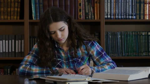 A student preparing for the exam in the library. 4K Stock Footage 63365430