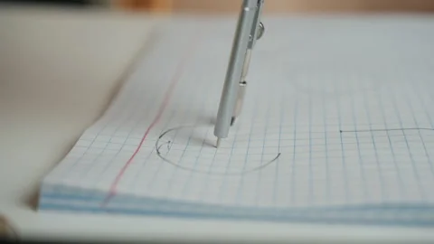 Student preparing for exam with precise compass and grid paper. Quiet study Stock Footage 336866448