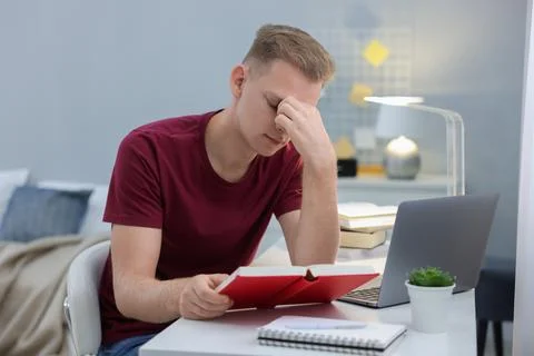 Student preparing for exam at table indoors Stock Photos