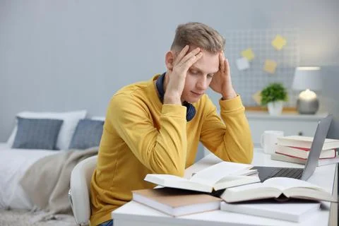 Student preparing for exam at table indoors Stock Photos