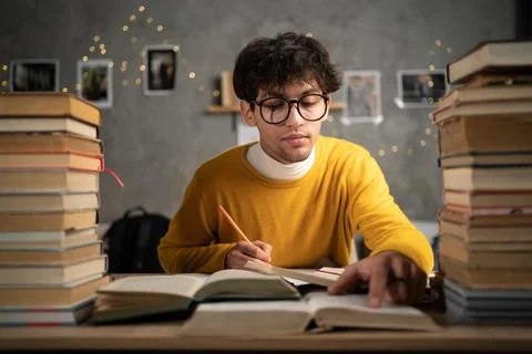 Student preparing for university exams at dormitory in the evening Stock Photos