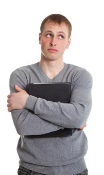 The student pressed to her breast a thick book Stock Photos