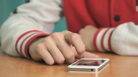 Student pressing finger on screen of smartphone Stock Footage 87574499