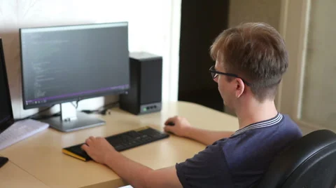 Student programmer work on the software code at home sitting at the computer. Stock Footage 64830523