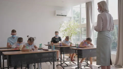 Student in protective mask studying at school during corona virus pandemic. A Video stock 157901063