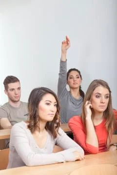 Student puts up her hand Stock Photos