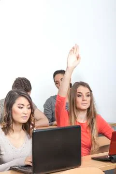 Student puts up her hand Stock Photos