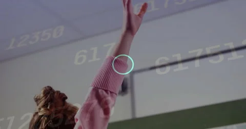 Student raising hand after overlay appearing in class, answering question amid Stock Footage 315533848