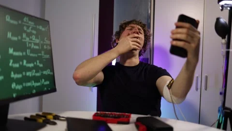Student reacts to biohacking test results while filming on smartphone Stock Footage 324443790
