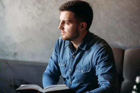 Student read book in cafe. Study and education. Young man spend time in cafe Stock-Fotos