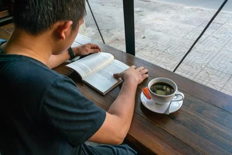 Student reading book and drinking coffee Stock Photos