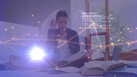 Student reading book and generating 3D sphere with data network then writing Stock Footage 312407393