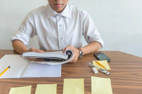 Student reading book and practicing on sticky notes Stock Photos