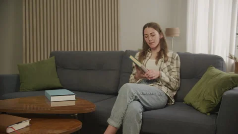 Student Reading a Book in Apartment Stock Footage 259304538