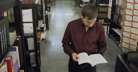 Student reading a book in the library. Concept: educational, portrait, library Stock-Footage 86199054