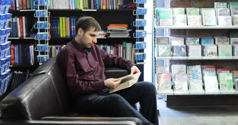 Student reading a book in the library. Concept: educational, portrait, library Stock Footage 86211100