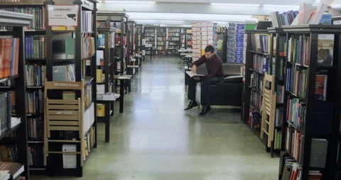 Student reading a book in the library. education concept Stock Footage 86202461