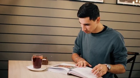 Student reading modern book in coffee shop Stock Footage 118214371