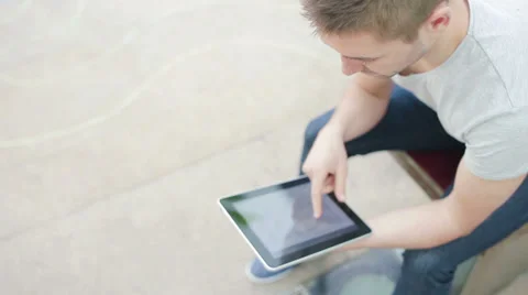 Student reading on tablet PC Stock Footage 39343211