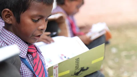 Student reading textbook at school in India Video stock 131048283
