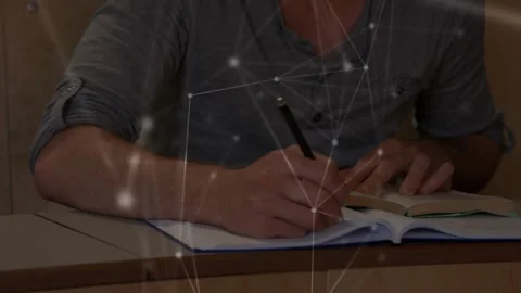 Student reading textbook taking notes with pen in notebook network drifting Stock Footage 334115311